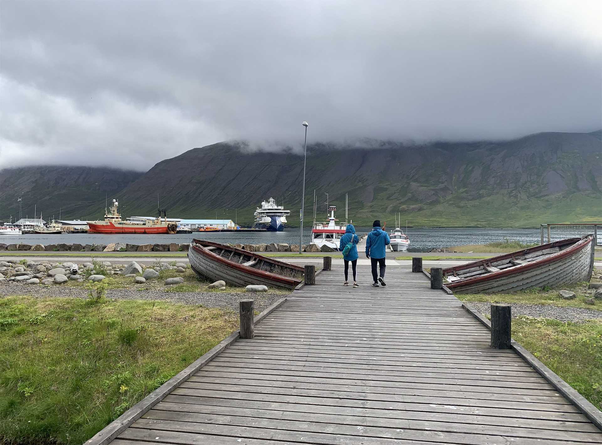 two people walking on a dock