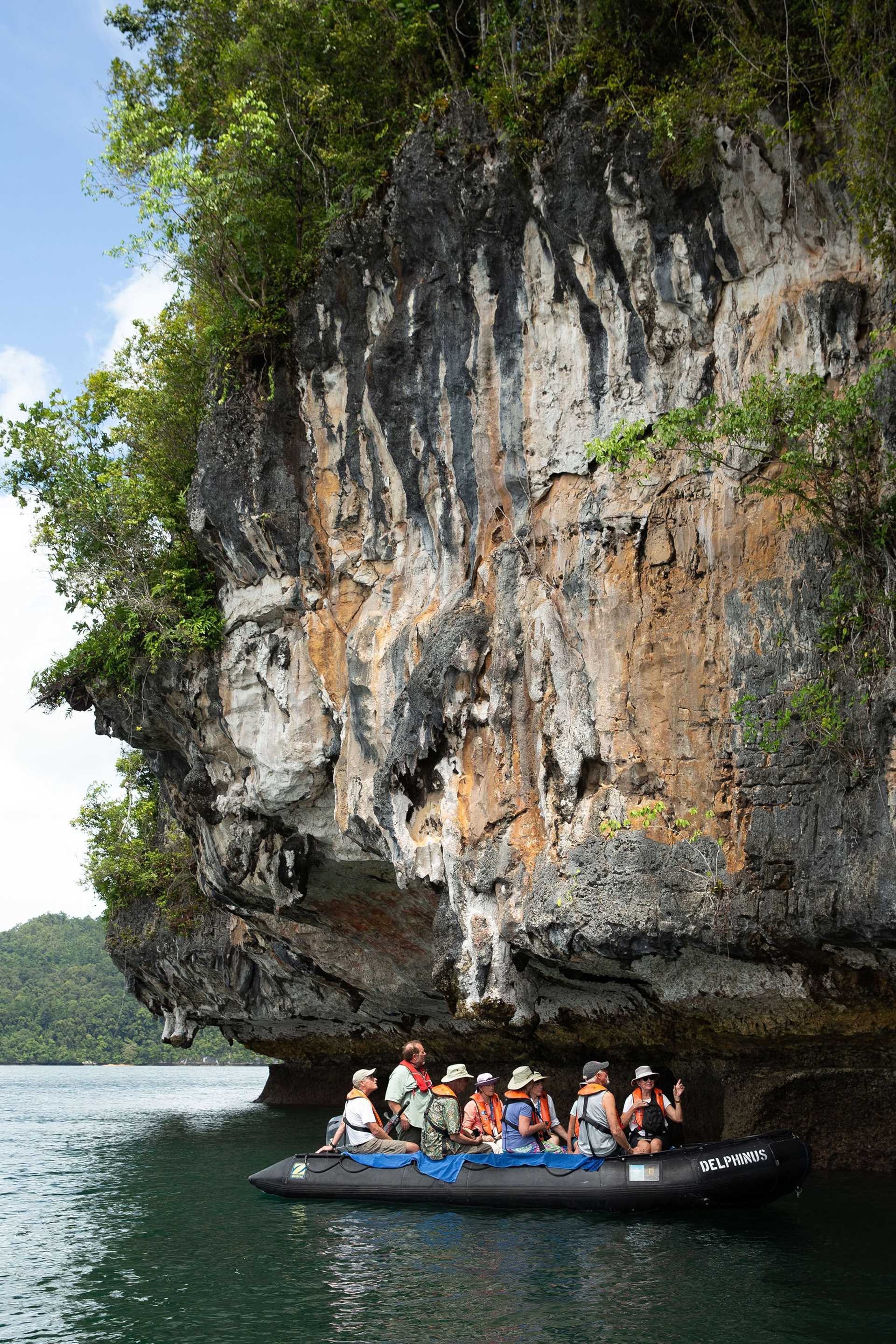 Zodiac in front of cliff 