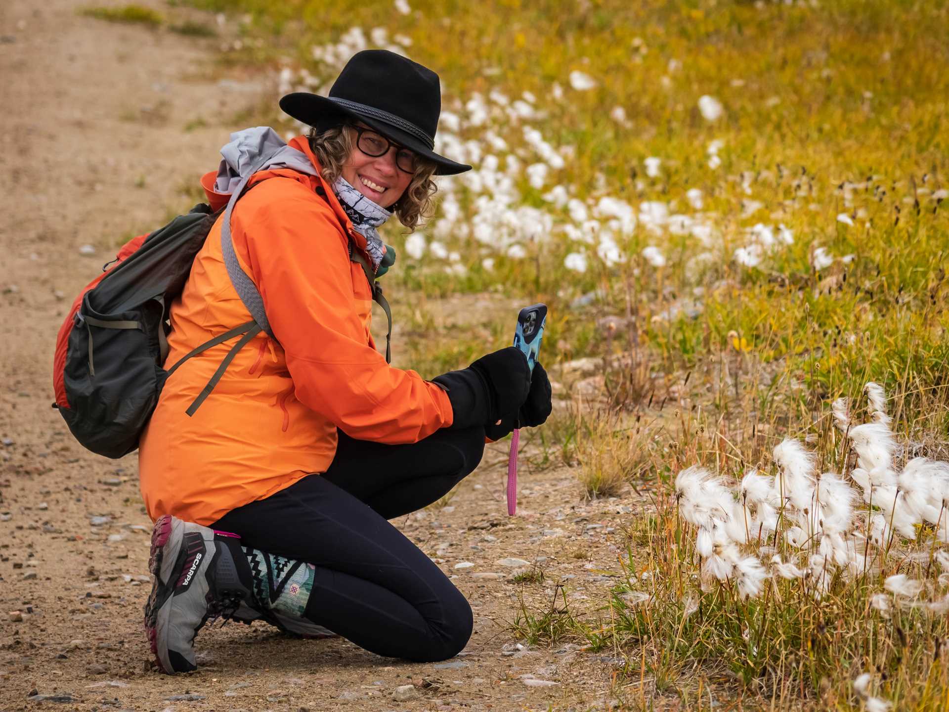 A guest photographs wildflowers in Buchan Gulf, Canada