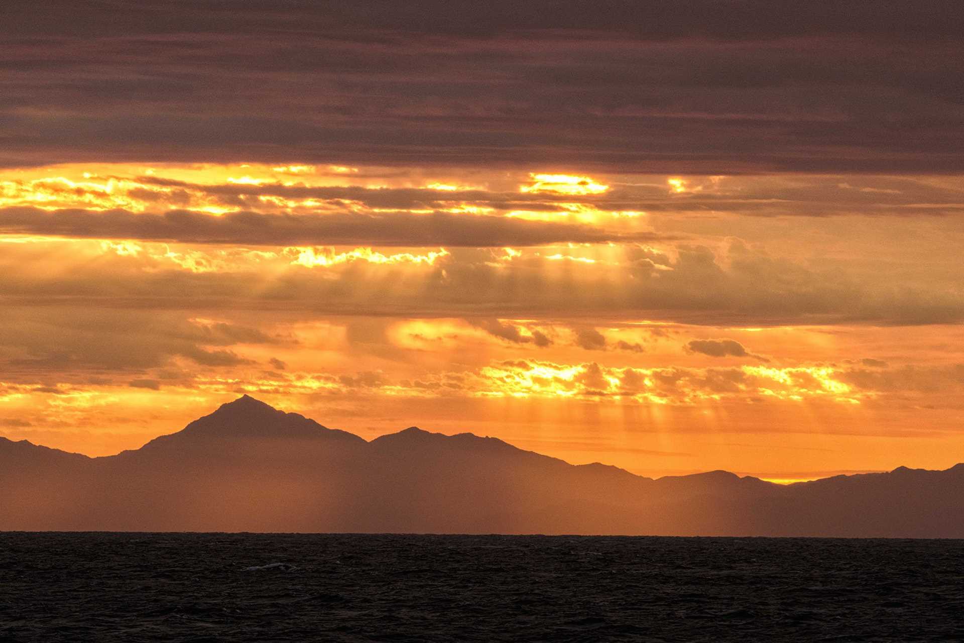 bright orange sunrise over water