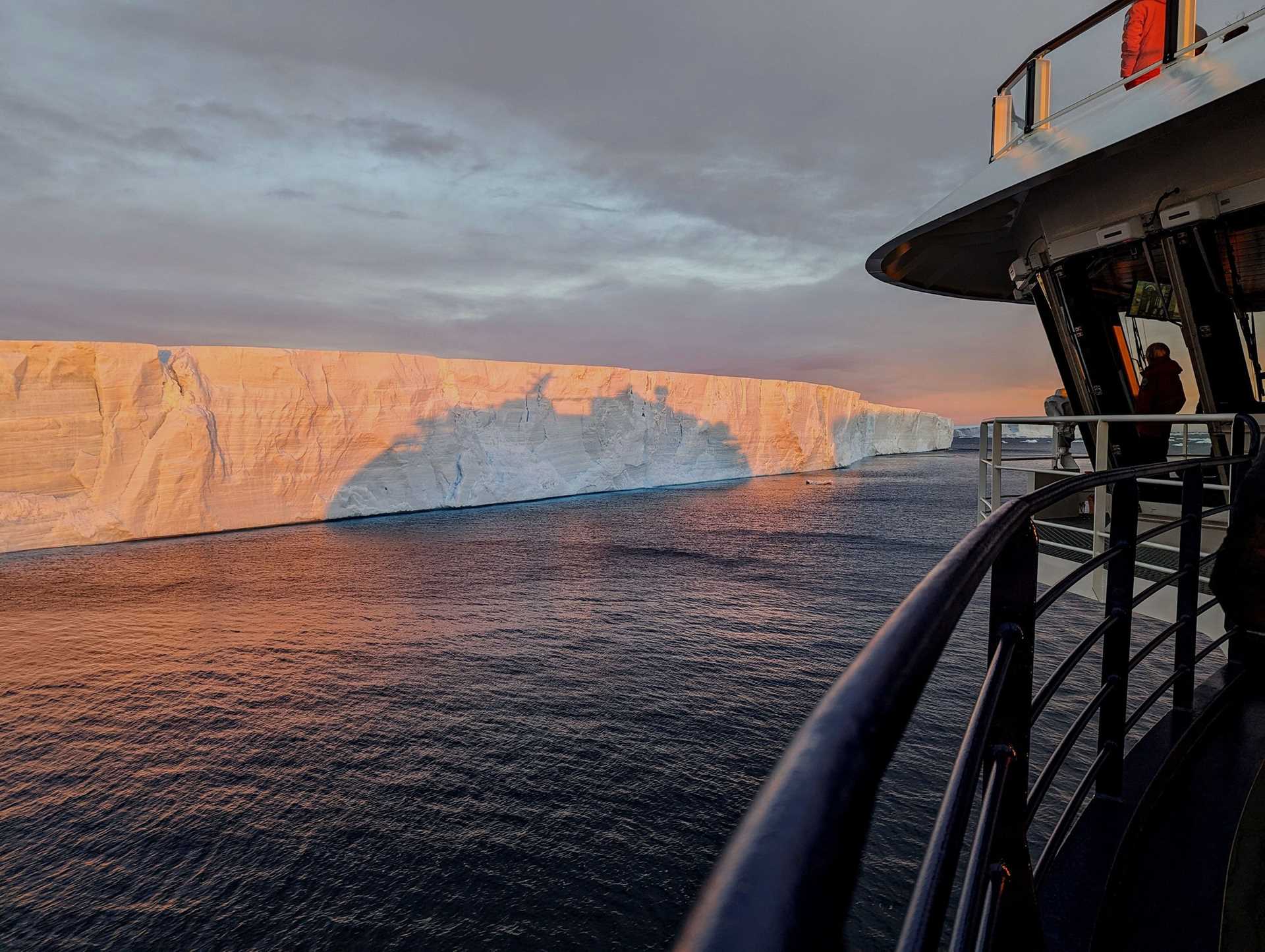 the deck of national geographic resolution in front of an iceberg