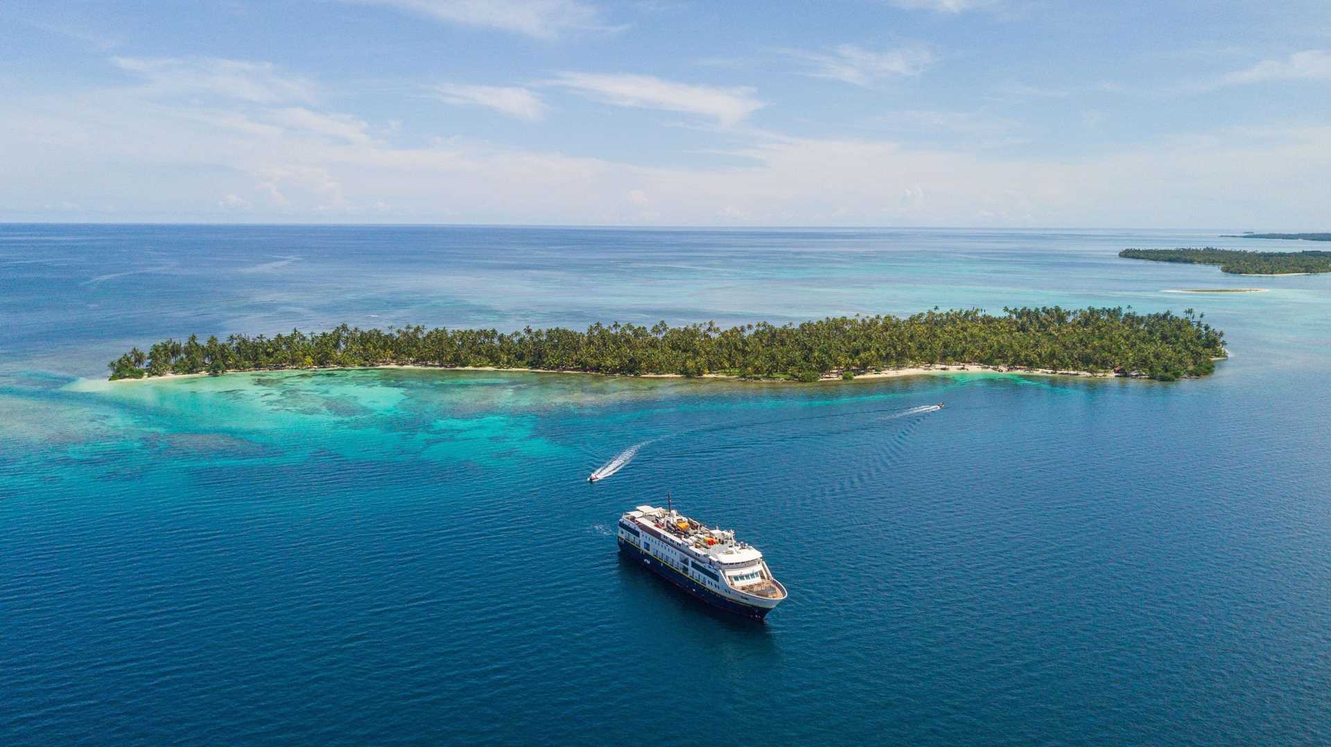 national geographic quest anchored next to a small island