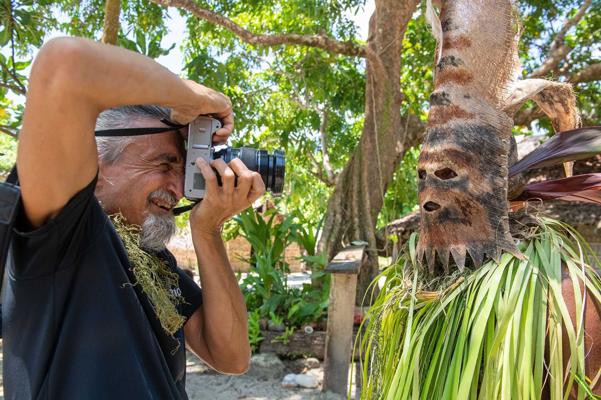 photographer taking a portrait of melanesian dancer