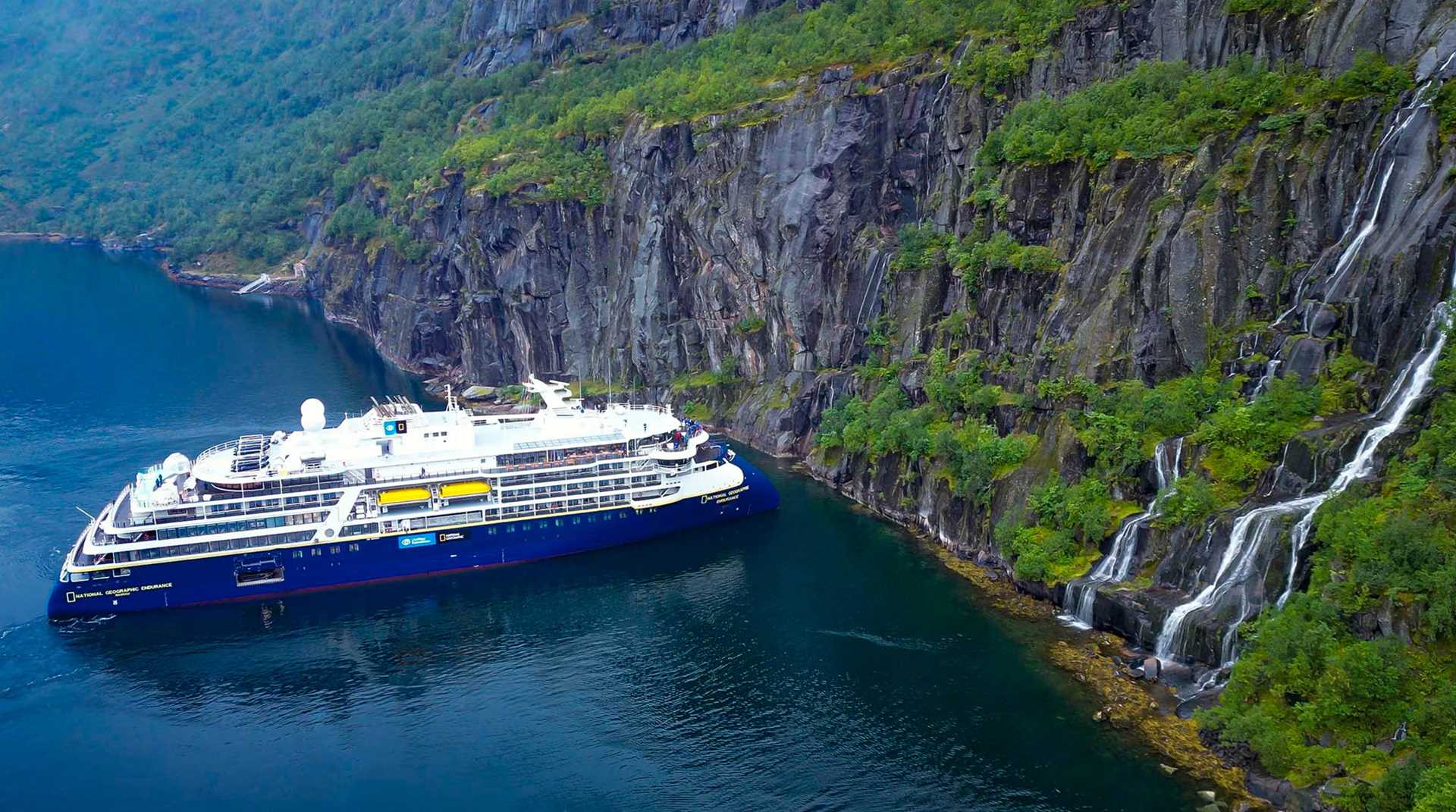 national geographic endurance ship next to high cliff face