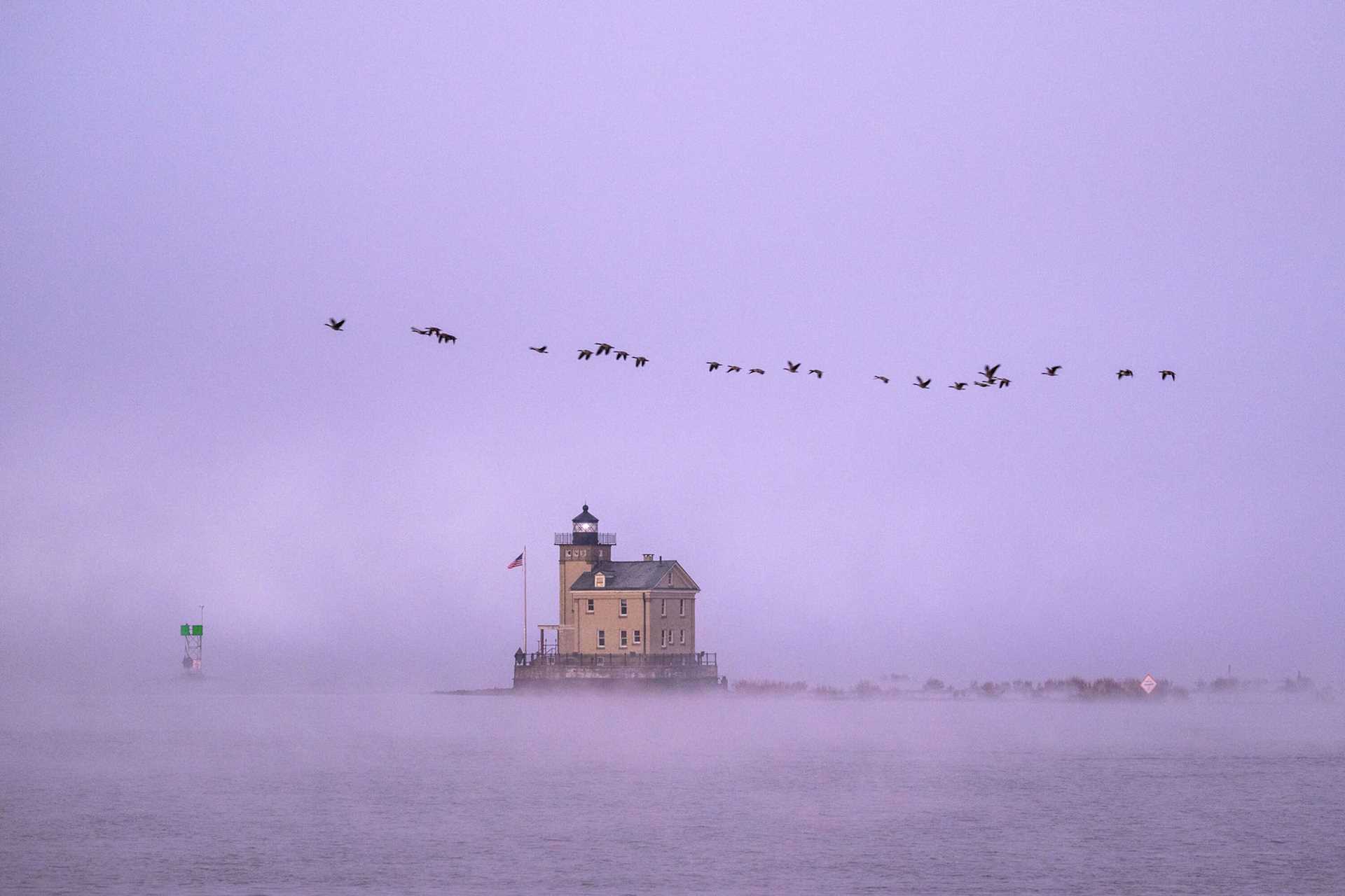 lighthouse against a purple sky