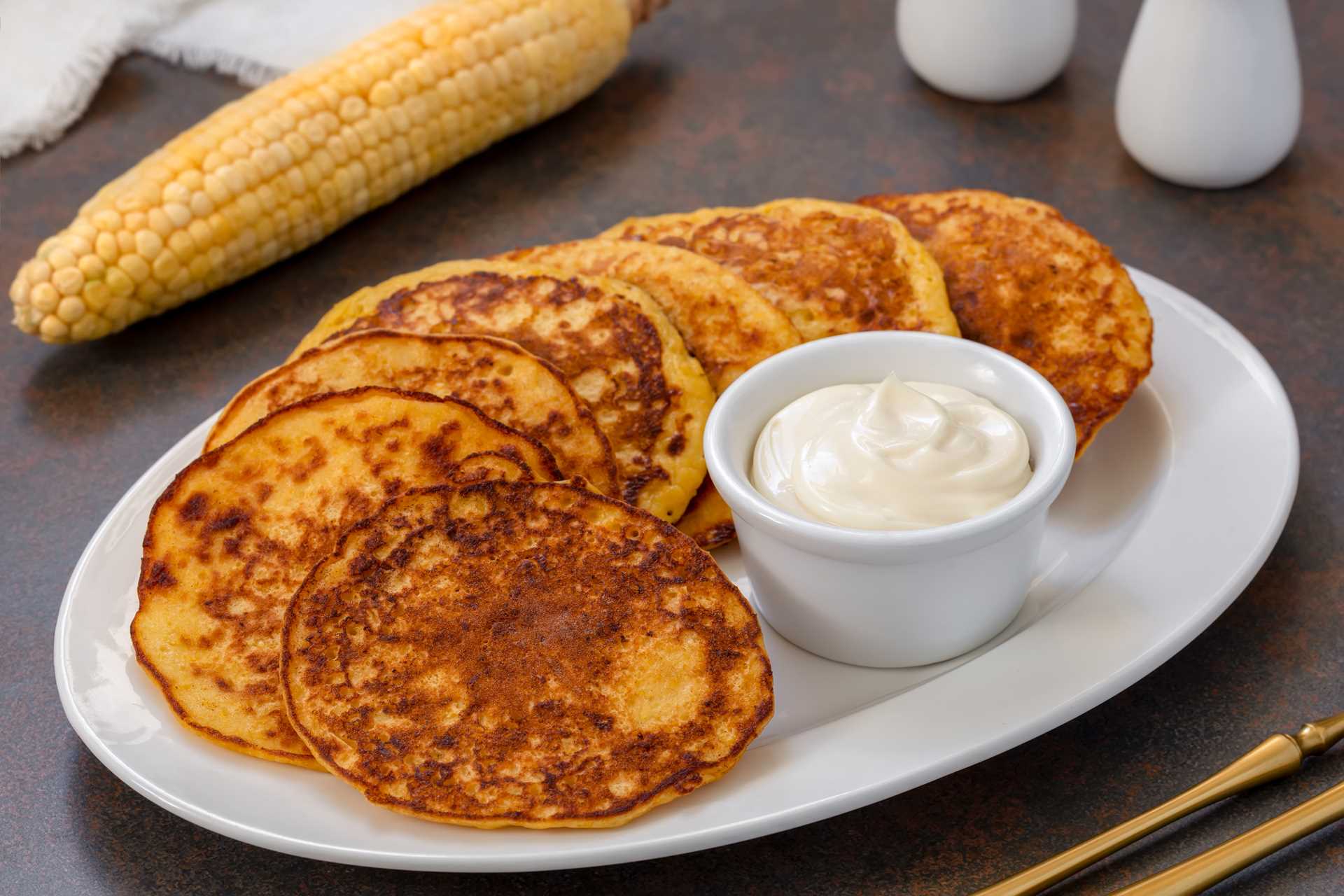 A plate of chorredas with a side of mayonnaise.